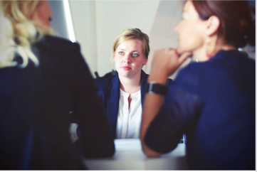 Woman listening intently during an office meeting