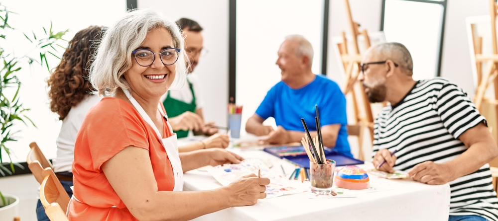 middle-age-students-in-painting-class-w-senior-female-looking-at-camera