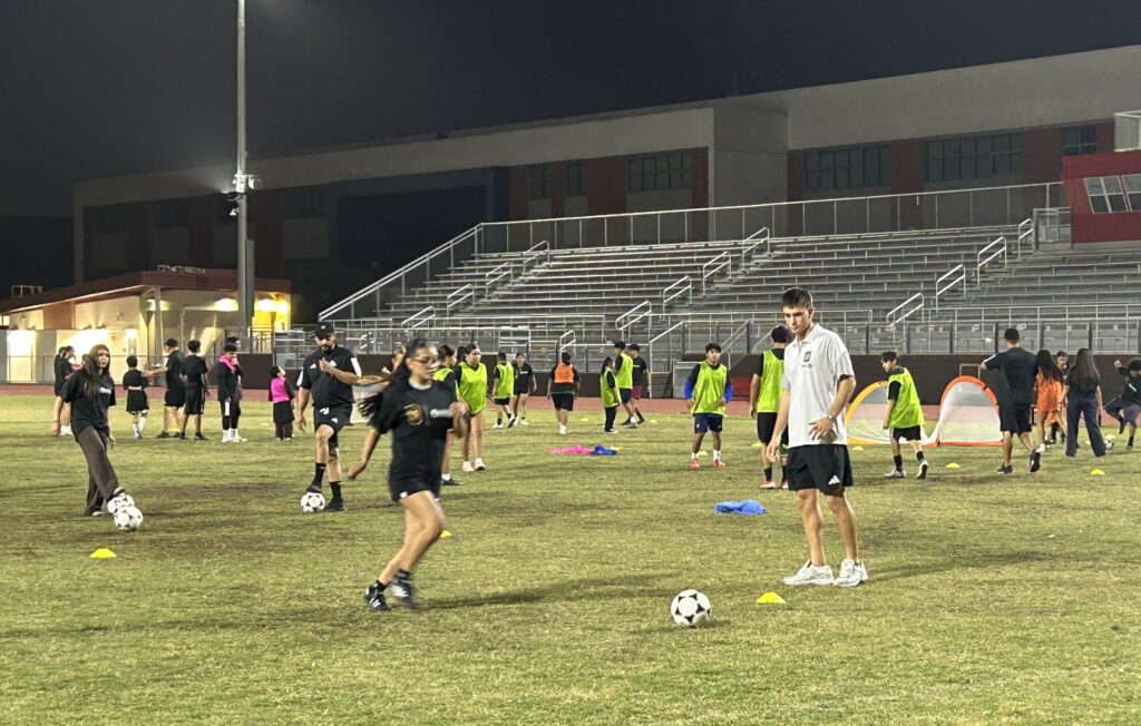 Students practicing soccer with LAFC player Tommy Mihalić
